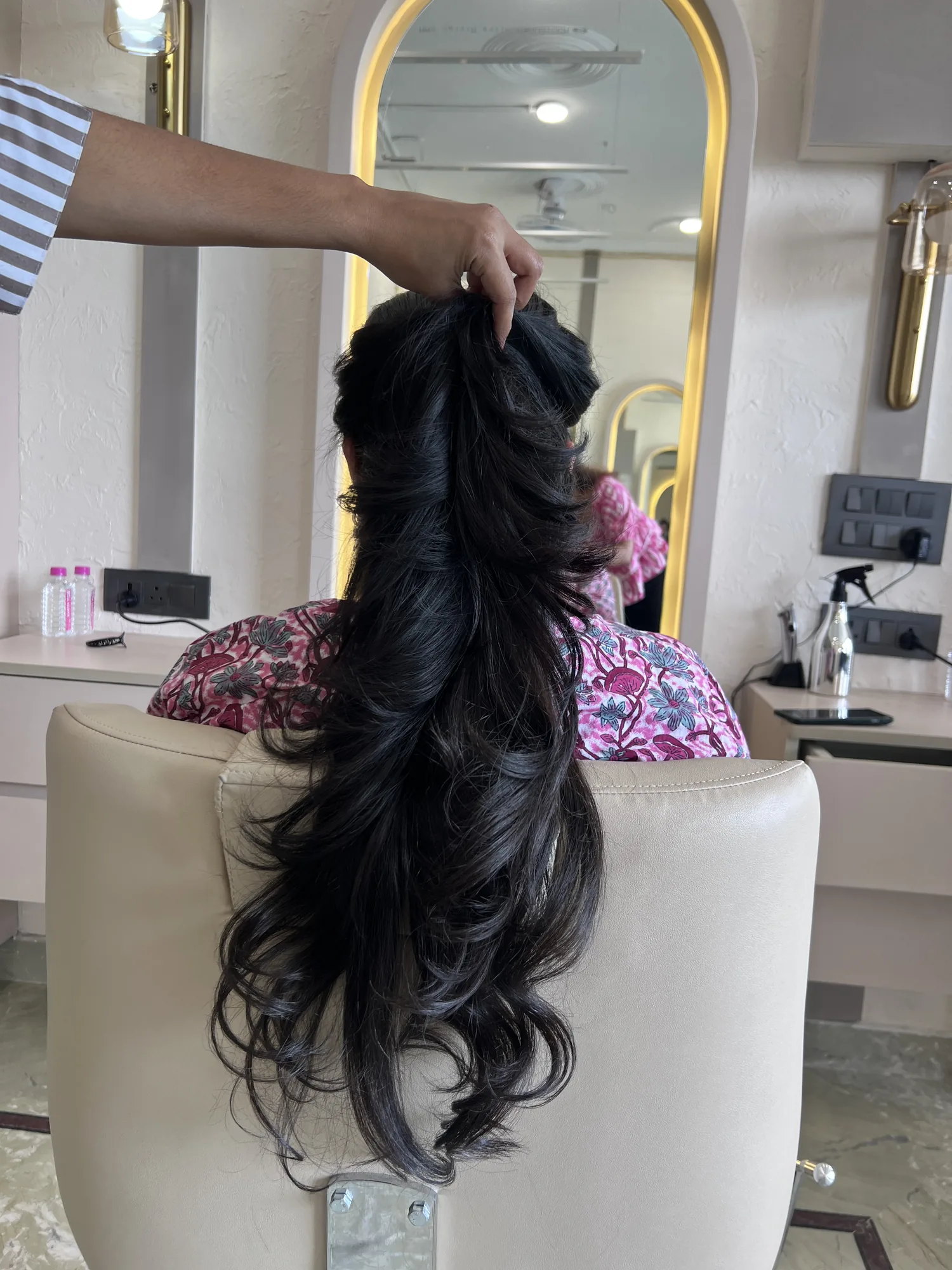 Long hair styled into soft bridal curls at the studio
