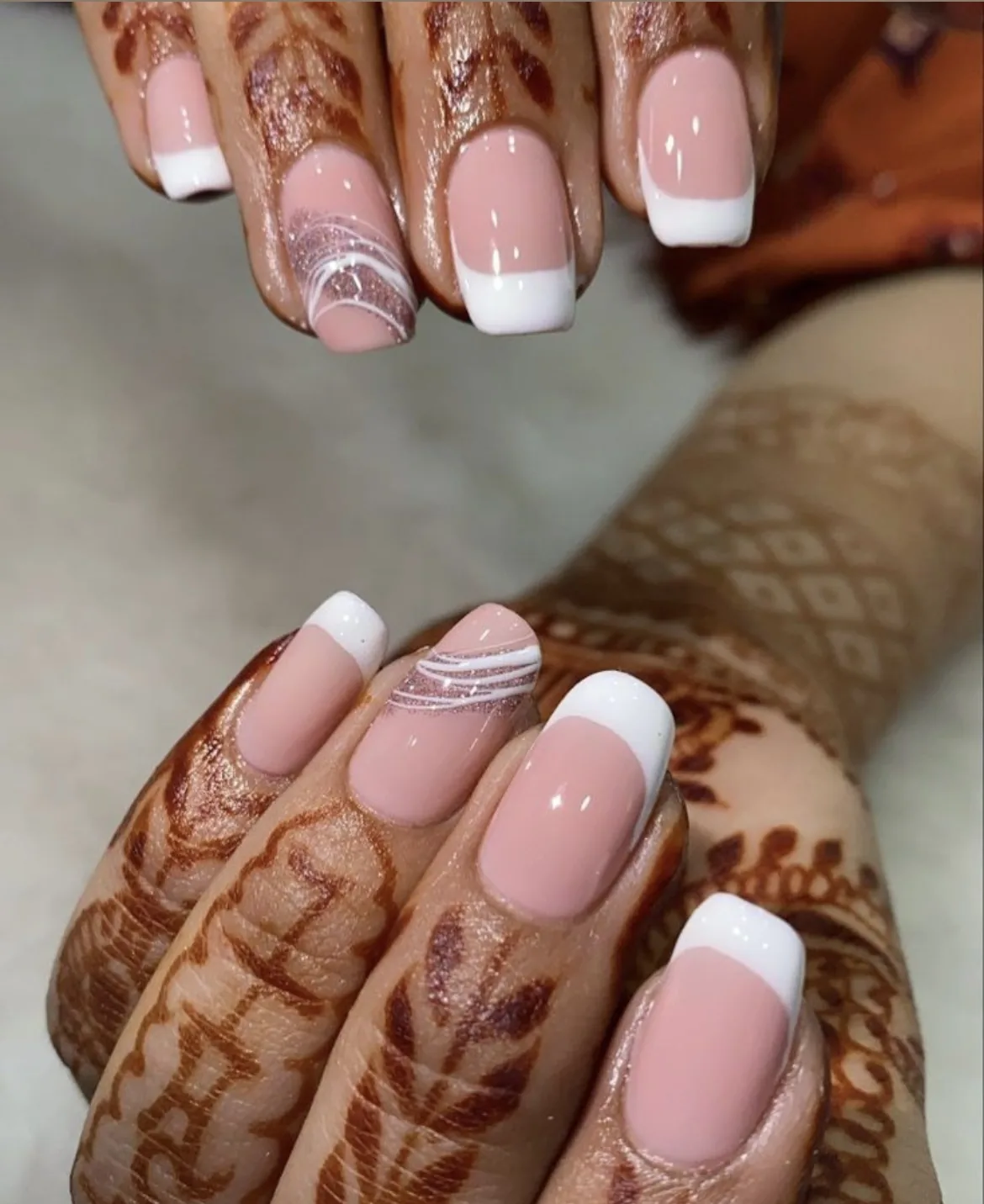 Pink and white nails with fine swirl art