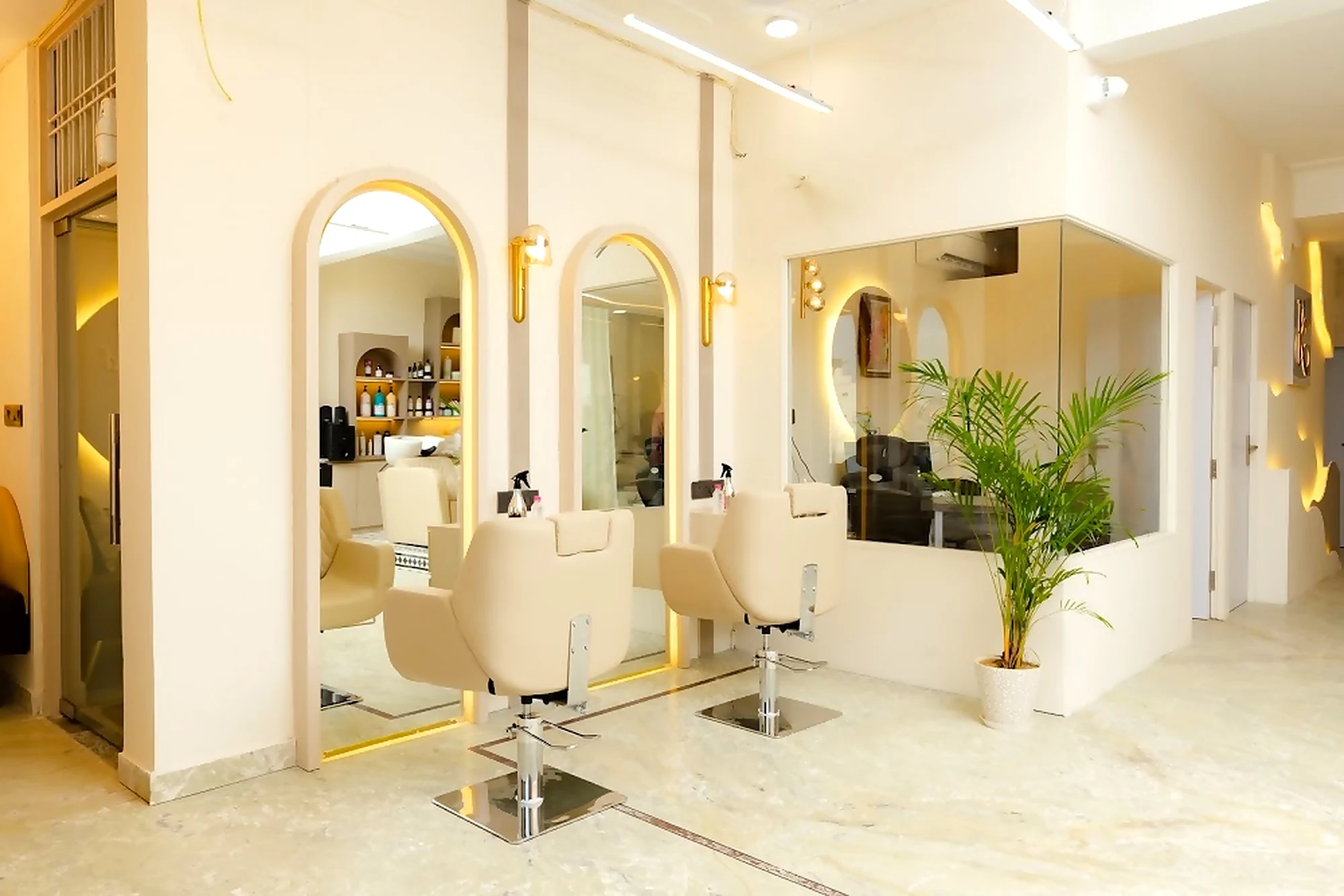 Styling station with backlit arch mirror and plant